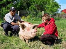 Emily and her husband, Vinod, with their favorite pig